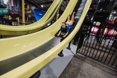 Kid sliding down a slide