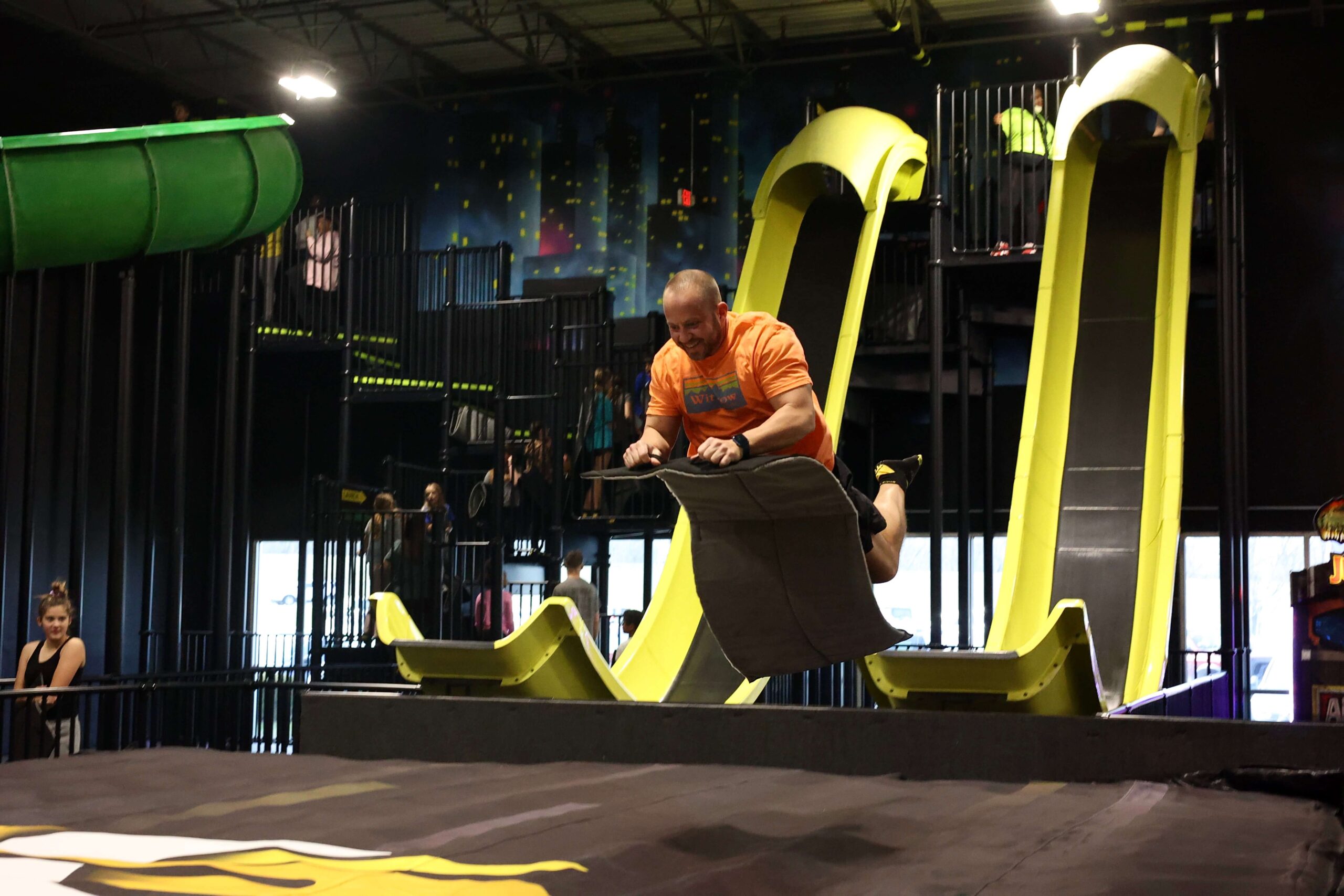 adult launching off of slide